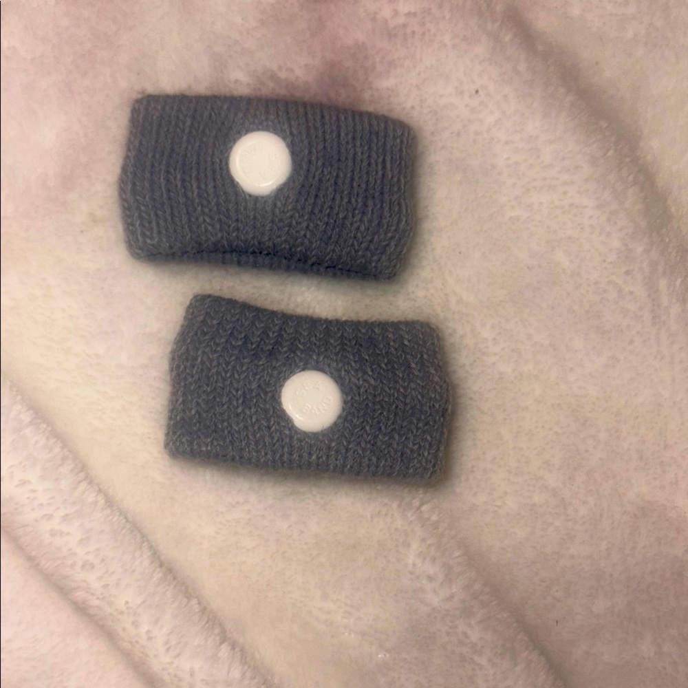 Gray Knit Wristbands with White Button Motion Sickness